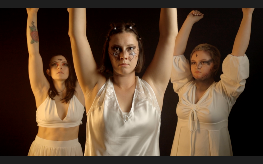 Three performers in a dramatic scene from Macbeth