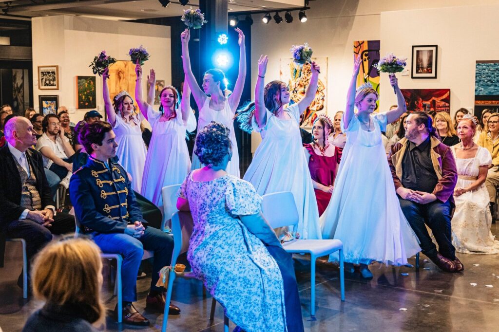 The Pride and Prejudice cast raising bouquets during a dance