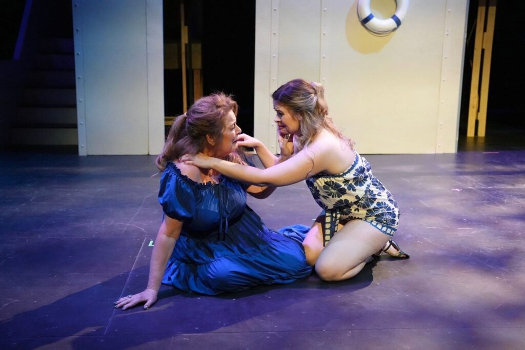 Two performers on the stage floor in a tender moment from Romeo and Juliet: Forever